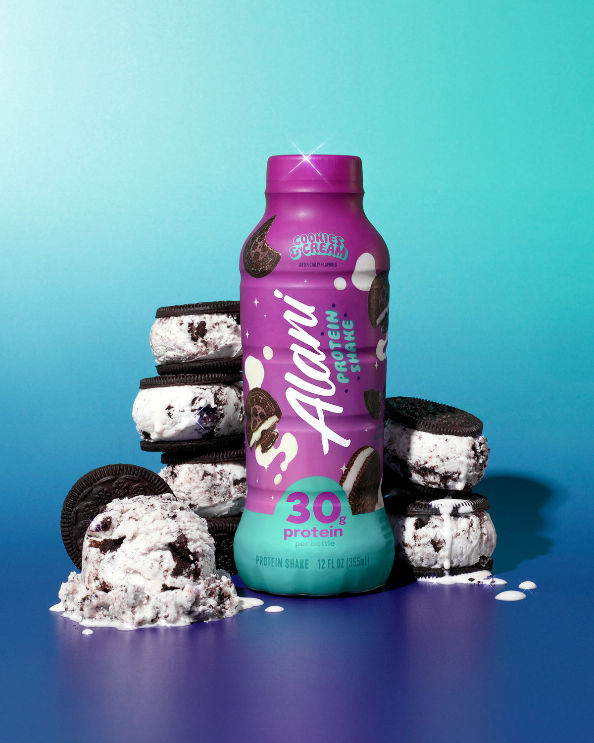 A bottle of Cookies &amp; Cream rests amid chocolate sandwich cookies stuffed with creamy ice cream against a blue gradient background.