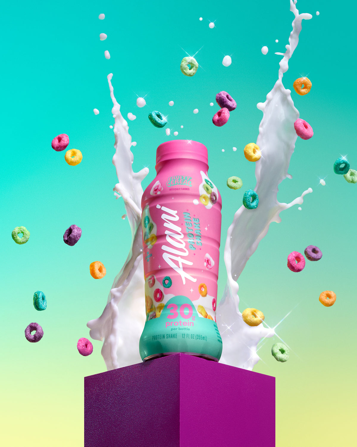 A bottle of Fruity Cereal sits on a purple ledge, surrounded by a confetti of fruity cereal and splashes of milk.