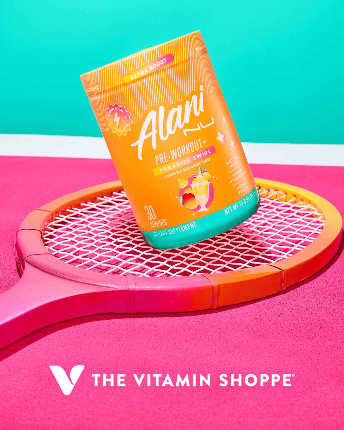 A container of Alani Nu&#39;s Pre-Workout + - Paradise Swirl supplement is placed on a pink and orange tennis racket with The Vitamin Shoppe logo below.