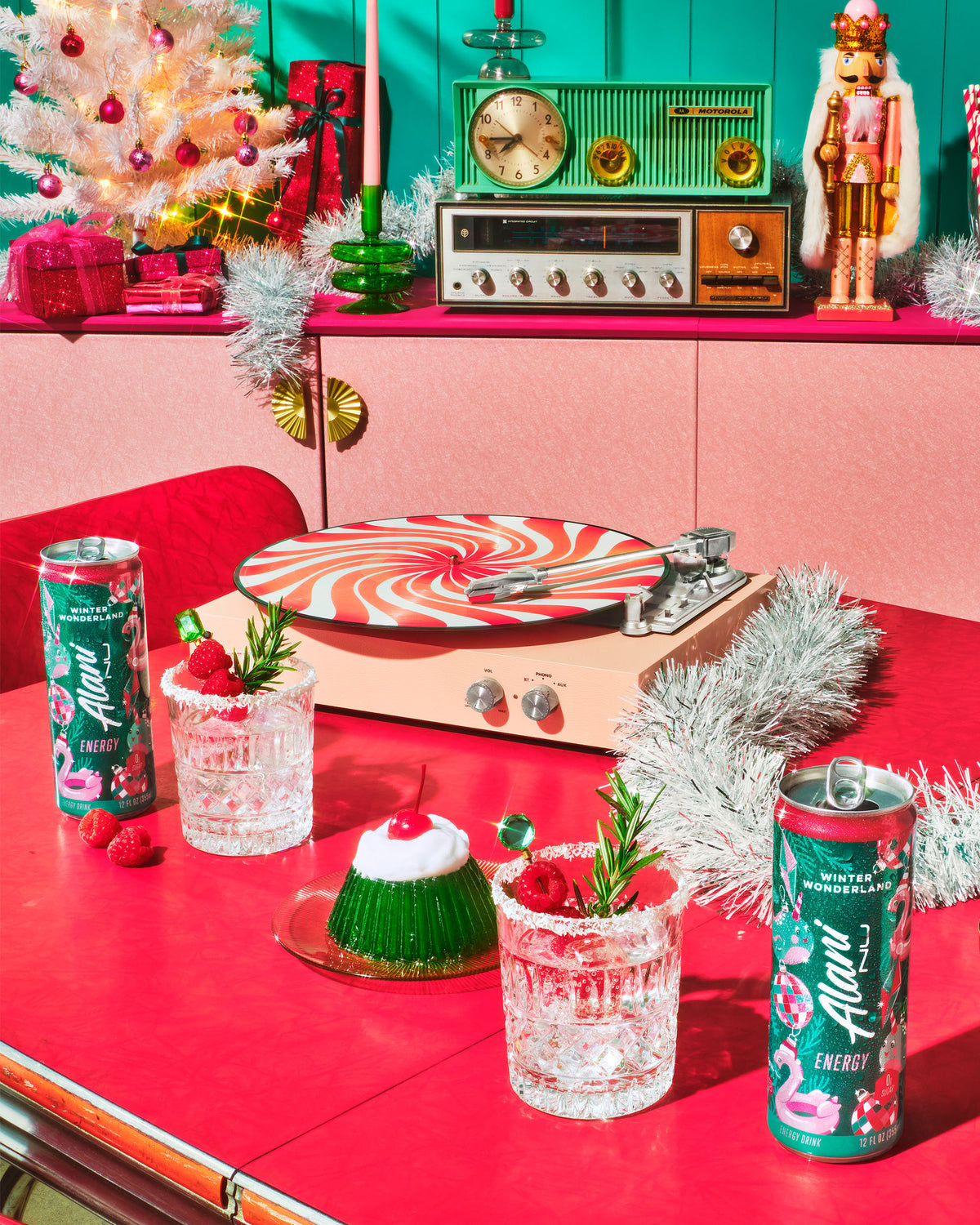 An Energy Drink rests on a table alongside frosted glasses, holiday decorations, and a peppermint-striped turntable. 